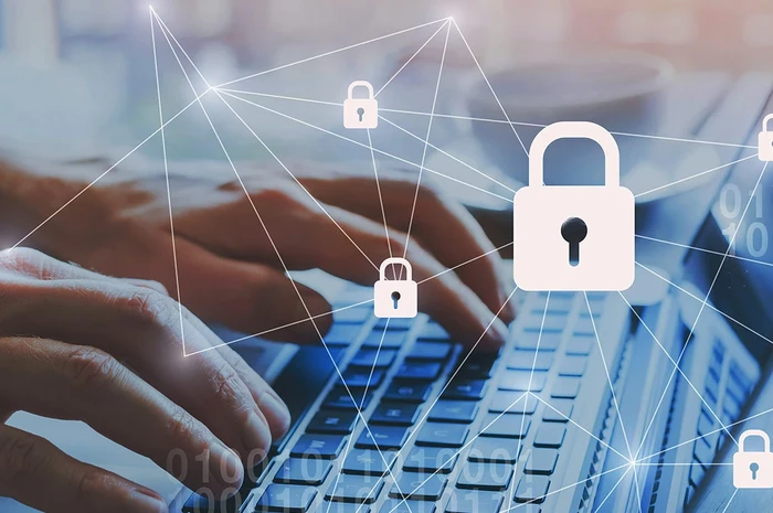Hände auf einer Computertastatur und Sicherheitsvorhängeschloss